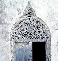 Ornate carved white archway